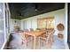 Inviting screened patio with ceiling fans and a stylish dining set, perfect for outdoor entertaining at 4260 Saint Lawrence Dr, New Port Richey, FL 34655