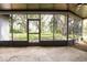 Spacious screened patio offering peaceful views of the lush green backyard, ideal for relaxation at 4260 Saint Lawrence Dr, New Port Richey, FL 34655
