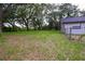 Well-maintained backyard featuring lush greenery and mature trees, providing a serene outdoor space at 4260 Saint Lawrence Dr, New Port Richey, FL 34655