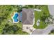 Aerial shot of property showing rooftop, surrounding yard, kidney-shaped pool, and circular driveway at 4353 Dewey Dr, New Port Richey, FL 34652