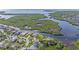 Aerial view of the property showcasing its location near a waterway and lush greenery at 4353 Dewey Dr, New Port Richey, FL 34652