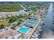Stunning aerial view of waterfront community with pool, tennis courts and boat docks along the canal at 4353 Dewey Dr, New Port Richey, FL 34652
