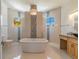 Bright bathroom featuring a soaking tub, walk-in shower, and stylish vanity with designer fixtures at 4353 Dewey Dr, New Port Richey, FL 34652