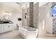 Luxurious bathroom with a soaking tub, tiled shower, and elegant lighting at 4353 Dewey Dr, New Port Richey, FL 34652