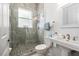 Modern bathroom featuring a glass shower, tiled walls, and a pedestal sink at 4353 Dewey Dr, New Port Richey, FL 34652