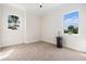 Bright bedroom with carpet flooring, two windows, and a dark wooden side table at 4353 Dewey Dr, New Port Richey, FL 34652