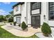 Elegant two-story home featuring a manicured lawn, decorative landscaping, and stately front entrance at 4353 Dewey Dr, New Port Richey, FL 34652