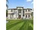 Beautiful two-story house showcasing a manicured front lawn and elegant architectural details at 4353 Dewey Dr, New Port Richey, FL 34652