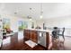 Kitchen featuring large island, stainless steel appliances, and dark wood flooring at 4353 Dewey Dr, New Port Richey, FL 34652