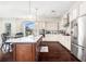 Gourmet kitchen featuring white cabinetry, a large center island, and stainless steel appliances at 4353 Dewey Dr, New Port Richey, FL 34652