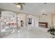 Spacious living room with white tiled floors, archways, a bar and comfortable seating, perfect for entertaining at 4353 Dewey Dr, New Port Richey, FL 34652