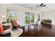 Bright living room with hardwood floors, large windows offering outdoor views, and stylish decor at 4353 Dewey Dr, New Port Richey, FL 34652