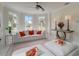 Bright living room with bay windows, a plush white sofa, and stylish decor at 4353 Dewey Dr, New Port Richey, FL 34652