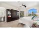 Carpeted main bedroom with a dark wooden cabinet and large window overlooking the property at 4353 Dewey Dr, New Port Richey, FL 34652