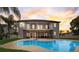 Beautiful backyard with a large swimming pool, screened patio, and ample space for outdoor relaxation and entertainment at 4353 Dewey Dr, New Port Richey, FL 34652