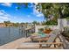 Inviting backyard featuring a waterfront patio with lounge chairs for relaxing by the water at 4649 Neptune Se Dr, St Petersburg, FL 33705