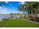 Lush backyard with manicured lawn and outdoor seating overlooking the serene waterfront at 4649 Neptune Se Dr, St Petersburg, FL 33705