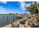 Gorgeous waterfront backyard with a fire pit and multiple seating areas, perfect for entertaining at 4649 Neptune Se Dr, St Petersburg, FL 33705