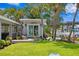 View of the beautifully landscaped backyard with tropical plants and a cozy outdoor space at 4649 Neptune Se Dr, St Petersburg, FL 33705