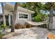 Relaxing backyard featuring a hammock strung between palm trees, surrounded by lush tropical plants at 4649 Neptune Se Dr, St Petersburg, FL 33705
