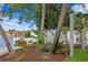 Waterfront view featuring a well-maintained backyard with lush greenery and tropical landscaping at 4649 Neptune Se Dr, St Petersburg, FL 33705