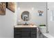 This bathroom features a single-sink vanity, modern lighting, and colorful artwork at 4649 Neptune Se Dr, St Petersburg, FL 33705