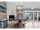 Charming dining area features a modern table and chairs, marble fireplace and waterfront views at 4649 Neptune Se Dr, St Petersburg, FL 33705