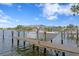 Boat dock featuring a boat lift, set against a backdrop of clear blue skies and calm water at 4649 Neptune Se Dr, St Petersburg, FL 33705