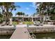 Expansive waterfront property showcasing lush landscaping, patio areas, and a private boat dock at 4649 Neptune Se Dr, St Petersburg, FL 33705