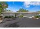 Charming single-story home with a well-maintained lawn and a spacious driveway leading to the garage at 4649 Neptune Se Dr, St Petersburg, FL 33705