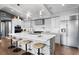 Modern kitchen with stainless steel appliances, a central island with seating, and sleek white cabinetry at 4649 Neptune Se Dr, St Petersburg, FL 33705