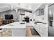 Bright kitchen with a center island, stainless steel appliances, white subway tile, and a modern range hood at 4649 Neptune Se Dr, St Petersburg, FL 33705