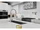 Modern kitchen with stainless steel appliances, a stylish range hood, and elegant countertops at 4649 Neptune Se Dr, St Petersburg, FL 33705