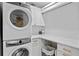 The laundry room includes a front-load washer/dryer set and ample storage space at 4649 Neptune Se Dr, St Petersburg, FL 33705