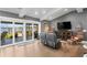 Inviting living area boasts a large sliding glass door, hardwood flooring and comfortable seating arrangements at 4649 Neptune Se Dr, St Petersburg, FL 33705