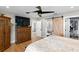 Spacious main bedroom features wood floors, a ceiling fan, a walk-in closet and ensuite bathroom at 4649 Neptune Se Dr, St Petersburg, FL 33705