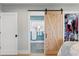 A sliding barn door accesses a bathroom and walk-in closet in this main bedroom at 4649 Neptune Se Dr, St Petersburg, FL 33705