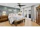 Serene main bedroom with wood floors, a ceiling fan and French doors leading to the outside at 4649 Neptune Se Dr, St Petersburg, FL 33705