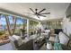 Covered patio with comfortable seating area, ceiling fan, and lush backyard view at 4649 Neptune Se Dr, St Petersburg, FL 33705