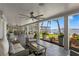 Covered patio with comfortable seating area, ceiling fan, and beautiful waterfront view at 4649 Neptune Se Dr, St Petersburg, FL 33705