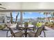 Covered patio with outdoor dining set, offering scenic views of the waterfront at 4649 Neptune Se Dr, St Petersburg, FL 33705