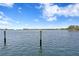 Wide water view showcasing waterfront living under a blue sky with scattered clouds at 4649 Neptune Se Dr, St Petersburg, FL 33705