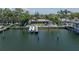 Waterfront house showcasing boat dock, boat, and outdoor seating near the sparkling waterway at 4649 Neptune Se Dr, St Petersburg, FL 33705