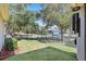 Backyard view featuring a lawn, fence, and neighborhood street at 5401 Match Point Pl, Lithia, FL 33547