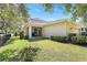 Well-manicured backyard with a covered patio, green lawn, and privacy fence at 5401 Match Point Pl, Lithia, FL 33547