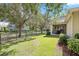 Backyard view featuring a lawn, fence, and mature trees at 5401 Match Point Pl, Lithia, FL 33547