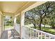 Balcony featuring white railing overlooking a beautifully landscaped neighborhood with mature trees at 5401 Match Point Pl, Lithia, FL 33547