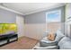 Bedroom featuring carpet, wainscoting, and a sofa near a window with blinds at 5401 Match Point Pl, Lithia, FL 33547