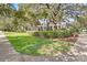 Beautifully landscaped front yard with lush greenery and mature trees at 5401 Match Point Pl, Lithia, FL 33547