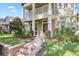Inviting home featuring a brick pathway, a cozy front porch, and lush landscaping at 5401 Match Point Pl, Lithia, FL 33547